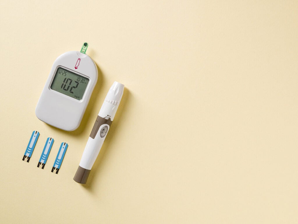 Glucometer and lancet pen on table