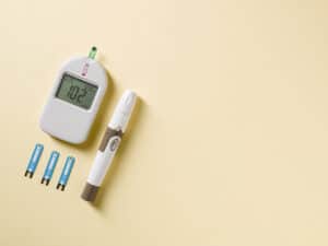 Glucometer and lancet pen on table
