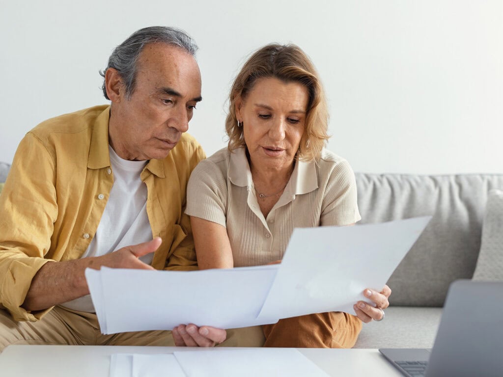 Middle aged couple reviewing ssd documents