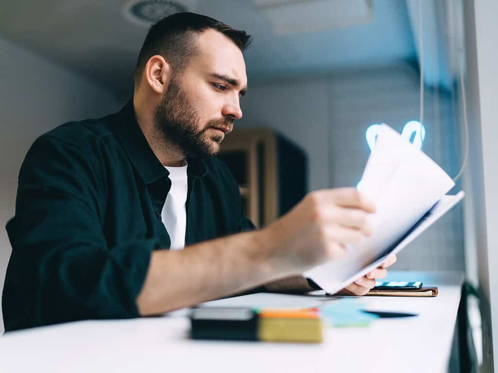 Serious man reviewing paperwork
