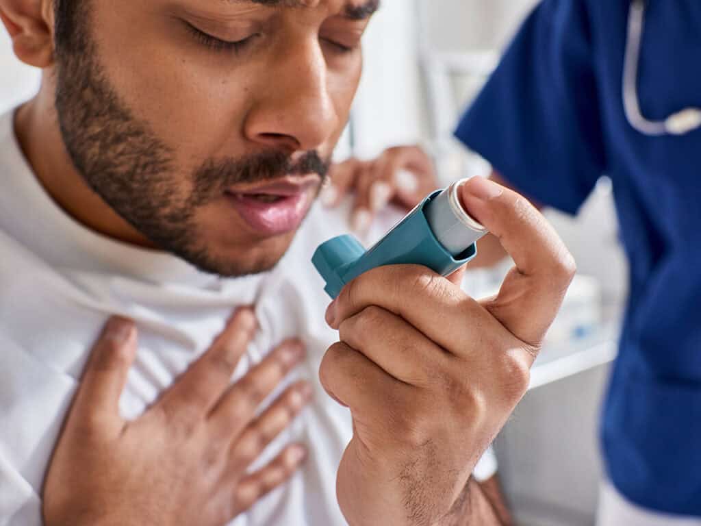 Male patient with asthma inhaler