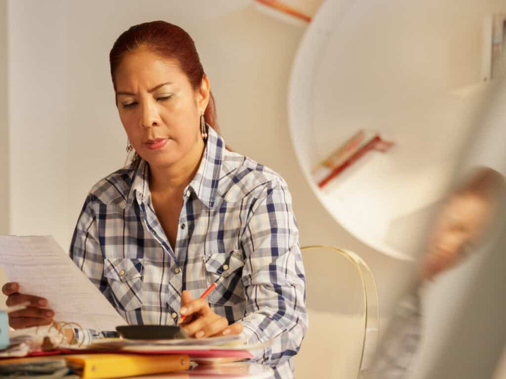 Woman filling out serious paperwork